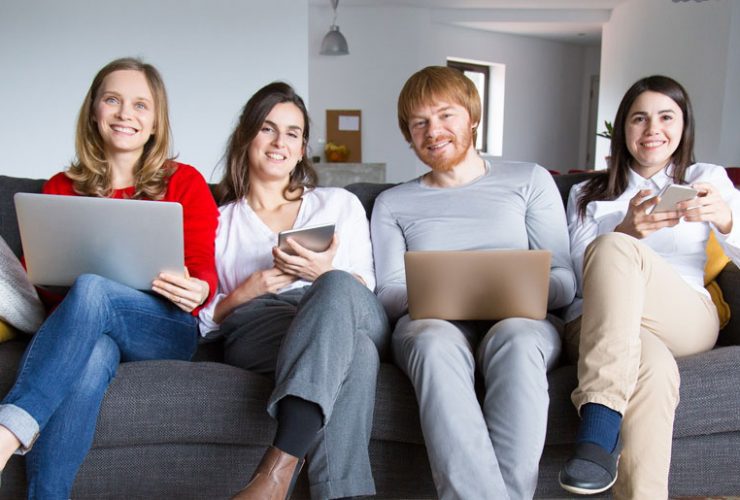 A group of people sitting on top of a couch.